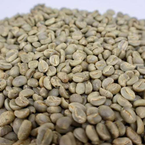 Green coffee beans on a white background